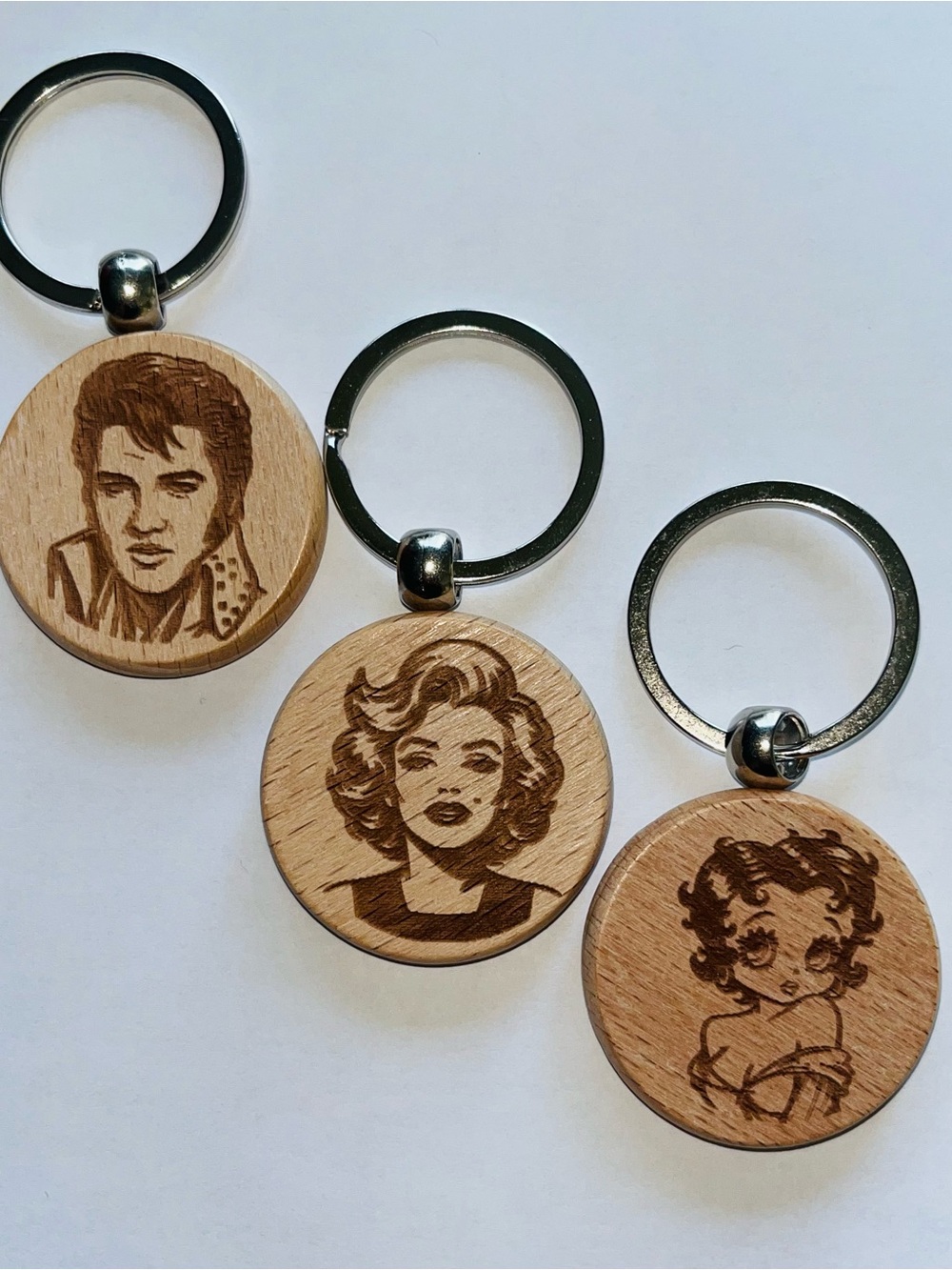 Set of 3… 1 1/2  inch Wooden Laser‑Engraved Celebrity Portrait Keychains